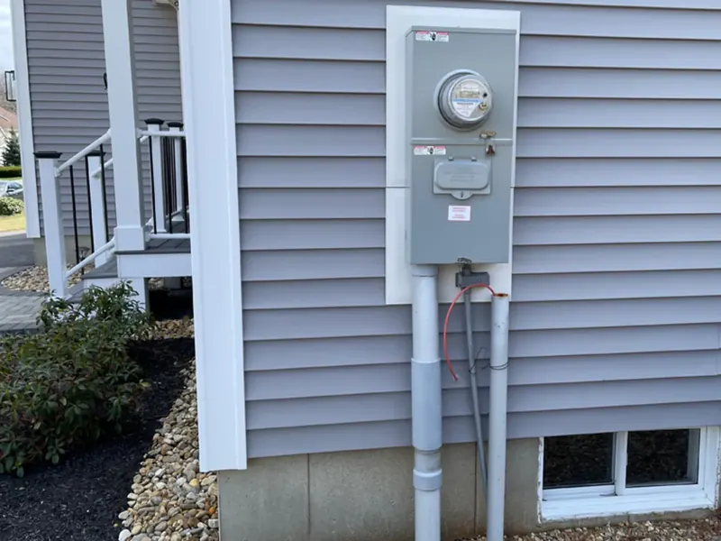 New 200-amp meter base and main disconnect installed on the exterior siding of a Southern NH home by A.J. LeBlanc Heating