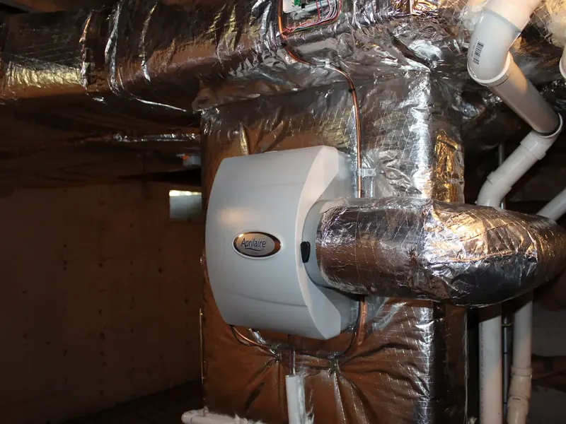Aprilaire bypass humidifier with bypass damper duct installed in a Southern NH basement utility room by A.J. LeBlanc Heating