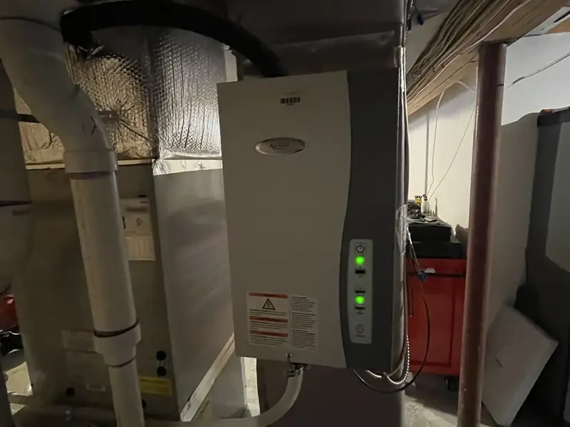Aprilaire steam humidifier installed beside a Bosch furnace in a Southern NH basement by A.J. LeBlanc Heating
