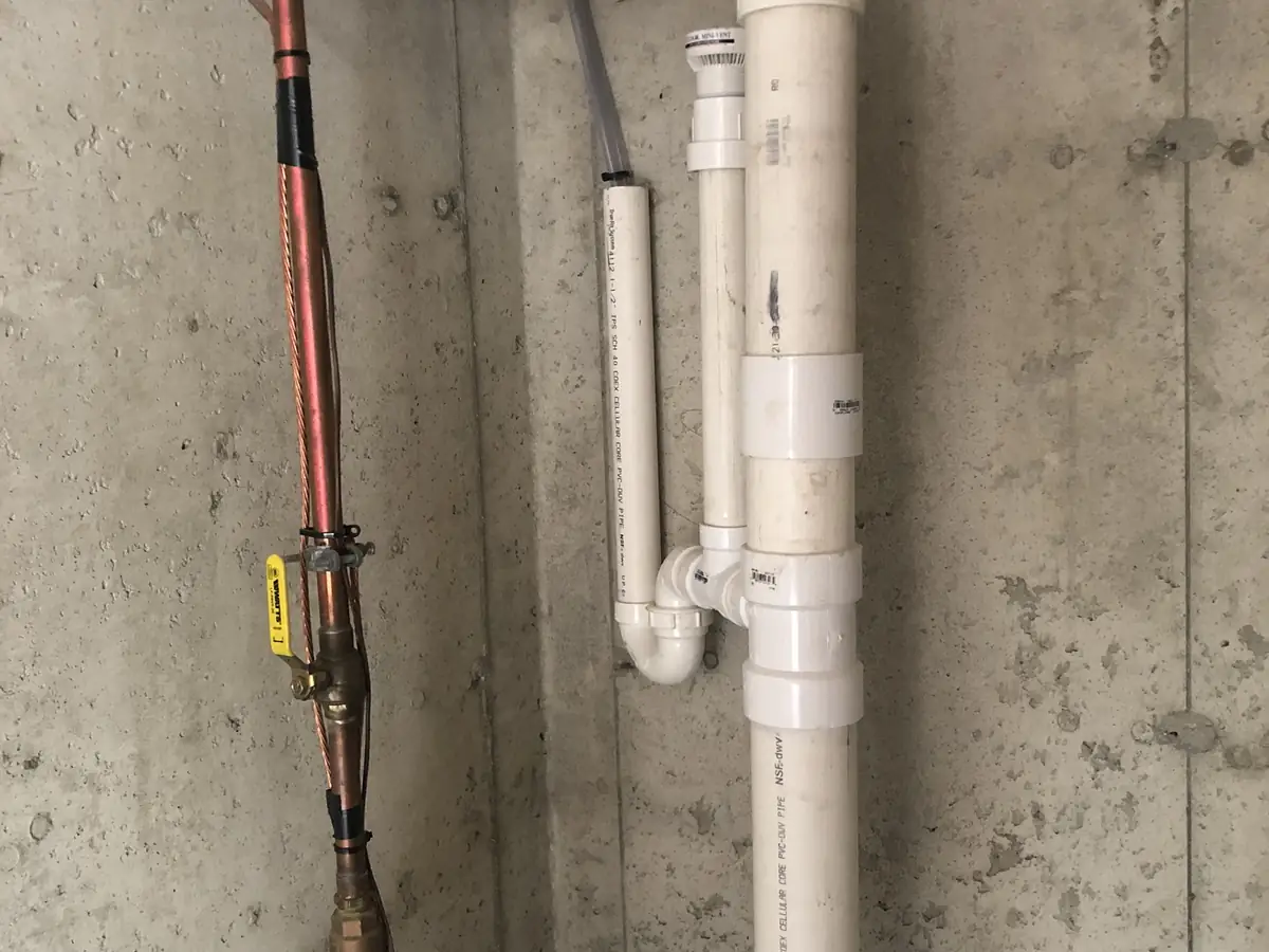 New PVC drain stack and copper water main installed by A.J. LeBlanc Heating in a Southern NH basement after a drain replacement