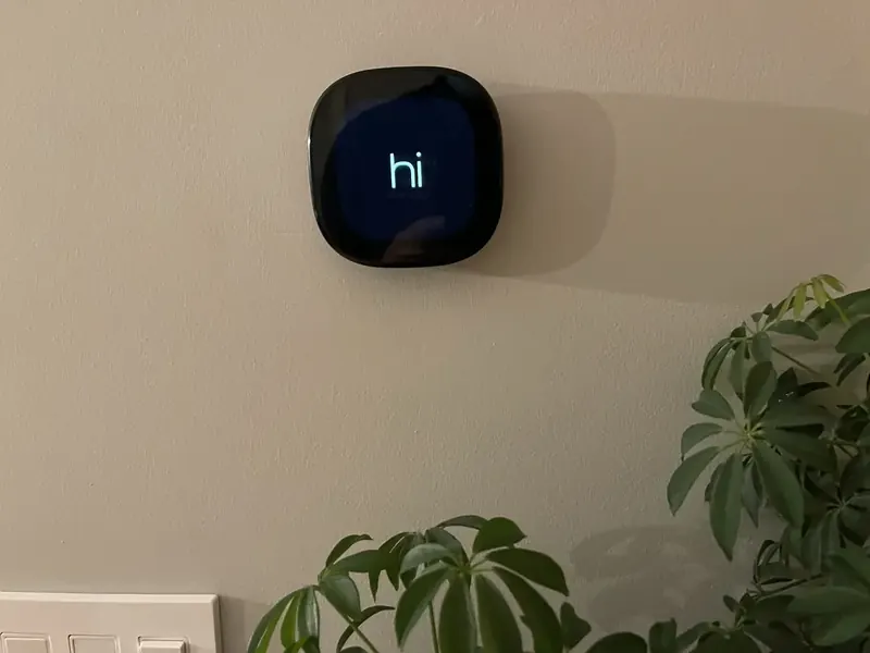 Ecobee Premium smart thermostat displaying the hi greeting screen installed by A.J. LeBlanc Heating in a Southern NH home