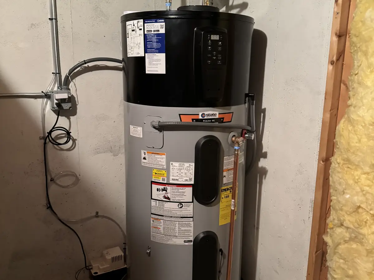 Hybrid heat pump water heater installation by A.J. LeBlanc Heating master plumbers in a Southern NH basement