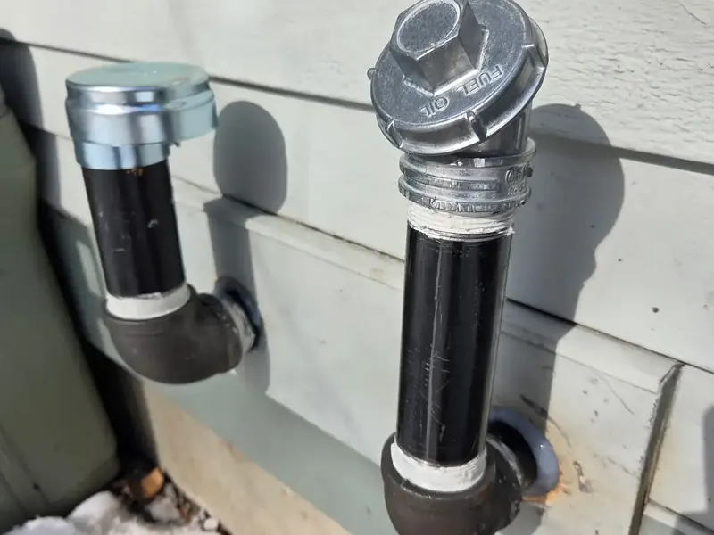 Outdoor oil tank fill and vent installed by A.J. LeBlanc Heating at a Southern NH home