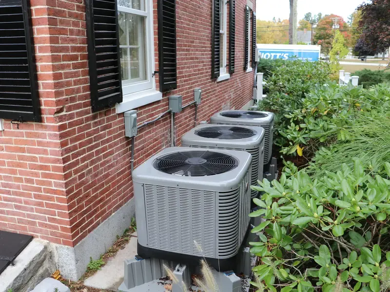 Rheem multi-zone heat pump installation with three outdoor condensers at a brick Southern NH home