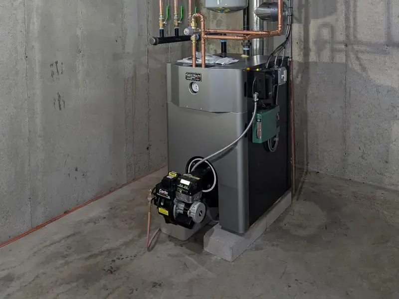Saint Roch cast-iron oil boiler with Carlin burner and copper multi-zone manifold in a Southern NH basement