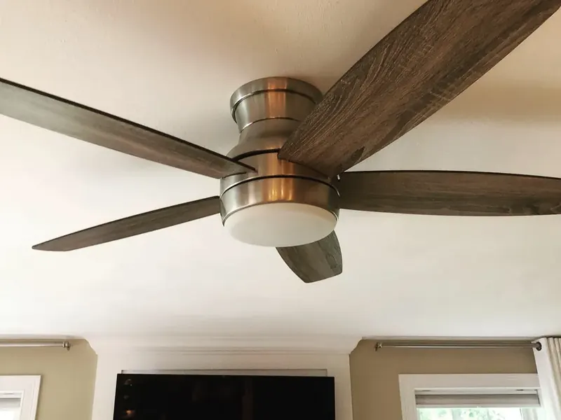 Wood-blade hugger ceiling fan with LED downlight installed by A.J. LeBlanc Heating in a Southern NH living room